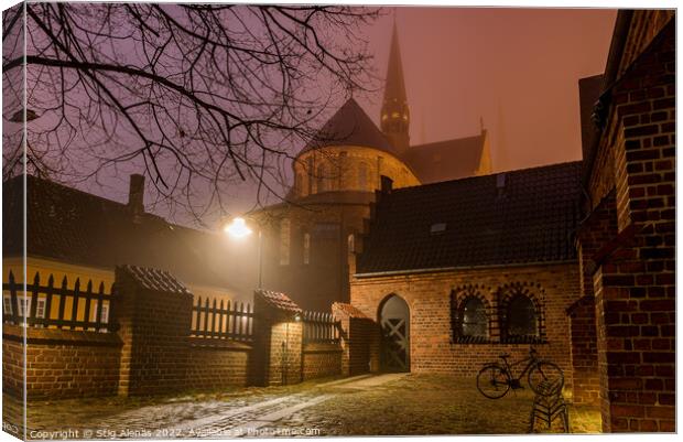 Roskilde cathedral and an illuminated yard with a bike a winter  Canvas Print by Stig Alenäs