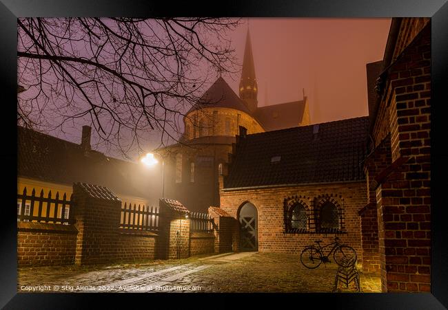 Roskilde cathedral and an illuminated yard with a bike a winter  Framed Print by Stig Alenäs