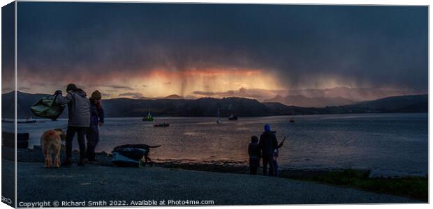 a shower of snow partially hides a sunset beyond loch Portree Canvas Print by Richard Smith