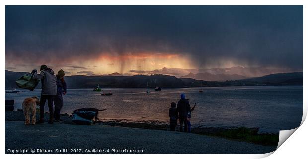 a shower of snow partially hides a sunset beyond loch Portree Print by Richard Smith