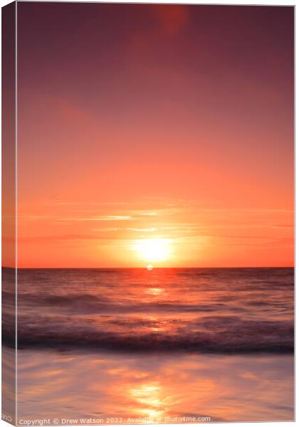 Sunrise over the sea. Canvas Print by Drew Watson