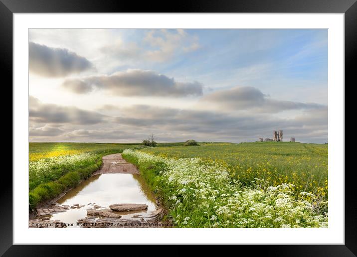 Flooded broken road leading to ruined Bawsey church Framed Mounted Print by Simon Bratt LRPS
