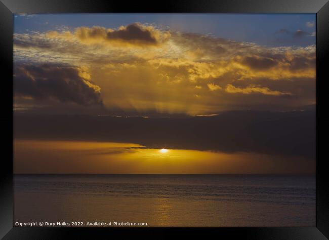 The sun breaking through the cloud cover over the Bristol channel Framed Print by Rory Hailes