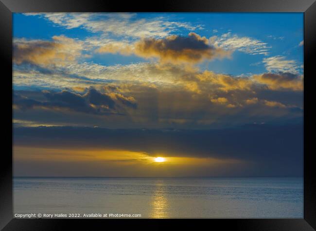 Sunset with a golden streak of sunlight going across the channel Framed Print by Rory Hailes