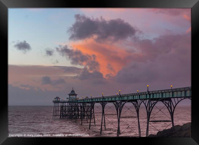 Clevedon Pier at sunset at low tide and choppy sea Framed Print by Rory Hailes