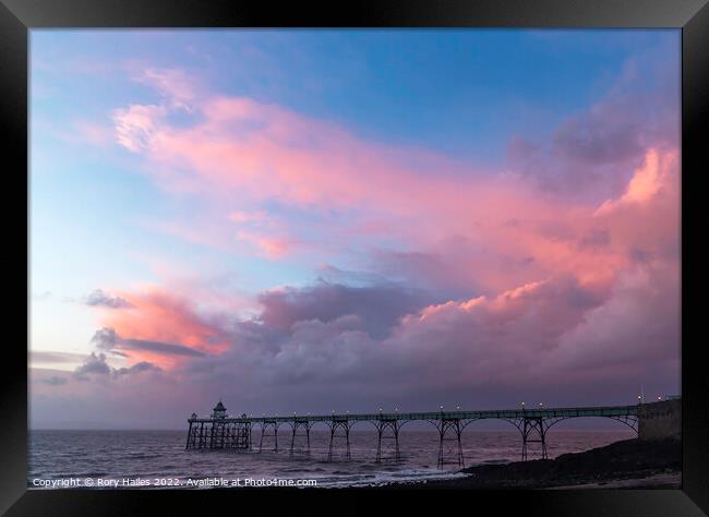 Clevedon Pier at sunset on a cloudy evening Framed Print by Rory Hailes