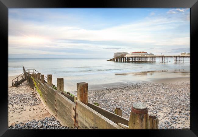Cromer Pier in Norfolk England with beach groin Framed Print by Simon Bratt LRPS