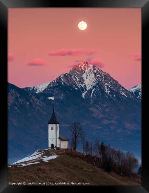 Full moon rising over Jamnik church and Storzic at sunset Framed Print by Ian Middleton