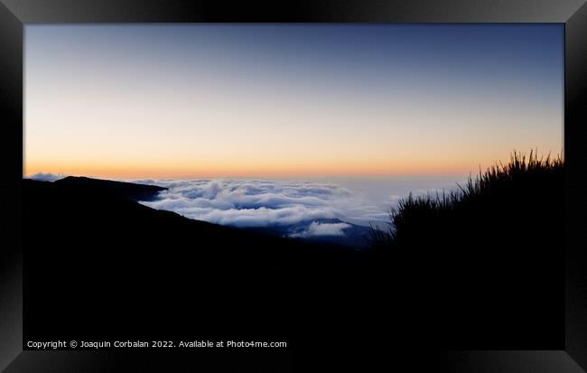 Relaxing sea of clouds at sunset in the hills near Mount Teide Framed Print by Joaquin Corbalan