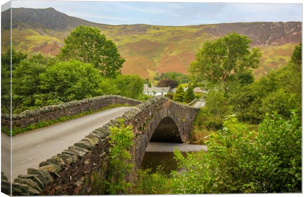 Bridge over small river at Grange in Lake District Canvas Print by Steve Heap