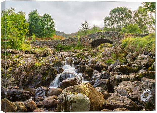Ashness Bridge over small stream in Lake District Canvas Print by Steve Heap