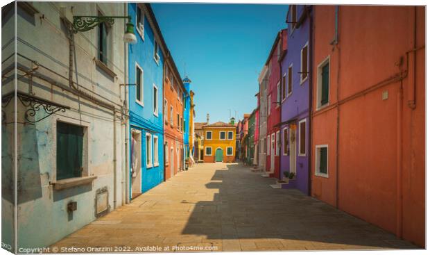 Burano island street, colorful houses in Venetian lagoon  Canvas Print by Stefano Orazzini