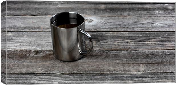 Dark coffee inside stainless steel mug on old wood table with co Canvas Print by Thomas Baker
