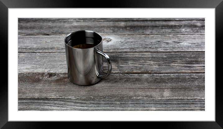 Dark coffee inside stainless steel mug on old wood table with co Framed Mounted Print by Thomas Baker