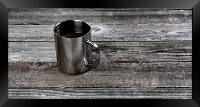 Dark coffee inside stainless steel mug on old wood table with co Framed Print by Thomas Baker