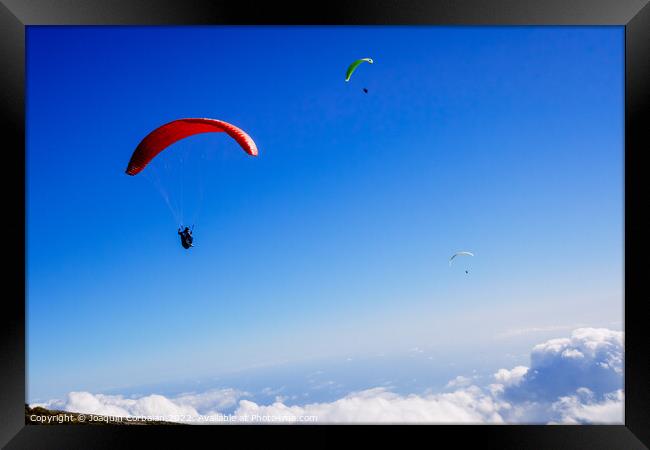 Athletes use an ultralight flexible glider, paraglider, to fly a Framed Print by Joaquin Corbalan