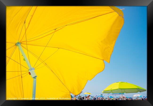 Beach holiday background, with a large yellow umbrella in the fo Framed Print by Joaquin Corbalan