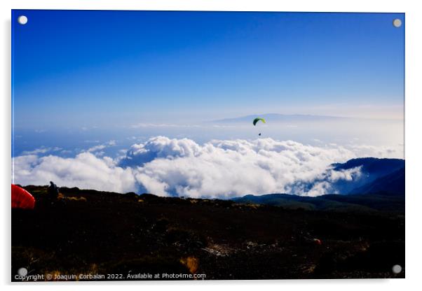 Paragliding above mountain peaks and white clouds during winter  Acrylic by Joaquin Corbalan