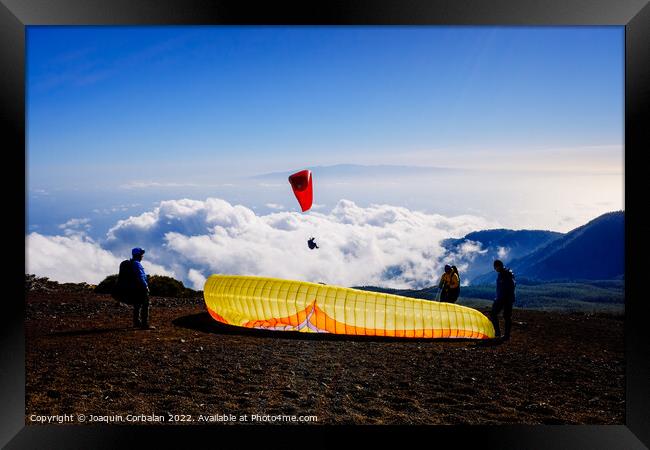 Skydiving experts and monitors prepare the sail of a paraglider  Framed Print by Joaquin Corbalan