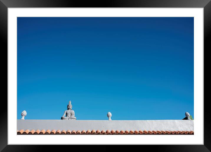 Buddha figure on roof Framed Mounted Print by Phil Crean