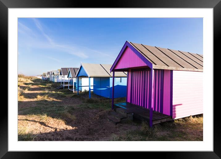 Lovely coloured beach hut  Framed Mounted Print by Clive Wells