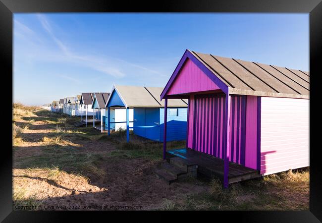 Lovely coloured beach hut  Framed Print by Clive Wells
