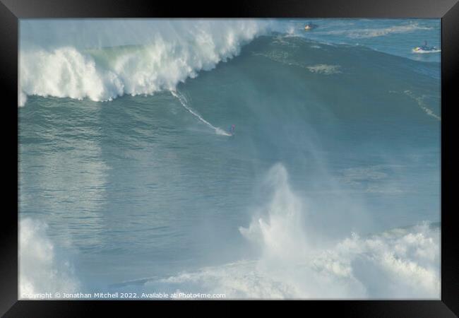 Surfer on a XXL wave at Nazare Portugal Framed Print by Jonathan Mitchell