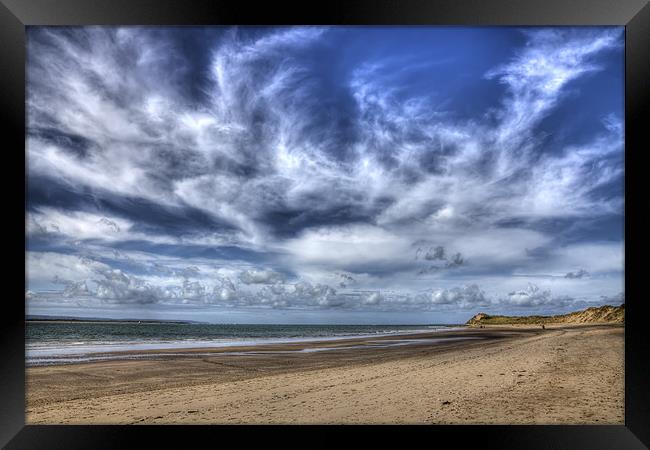 Swirling clouds and blue skies over Saunton Devon Framed Print by Mike Gorton