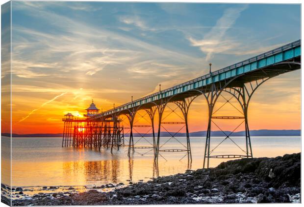 Clevedon Pier on a bright evening with colourful reflections Canvas Print by Rory Hailes