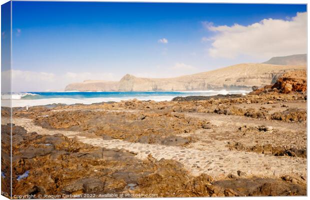 Atlantic rocky coast washed by the ocean on a sunny day with blu Canvas Print by Joaquin Corbalan