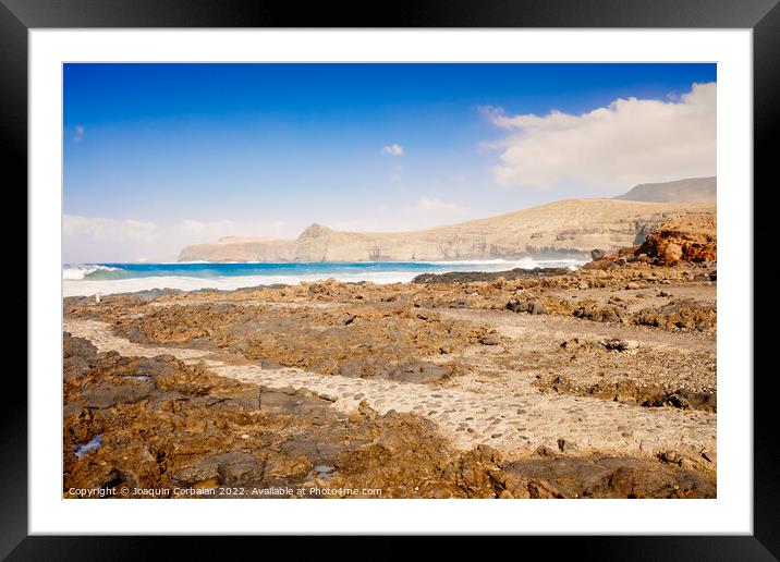 Atlantic rocky coast washed by the ocean on a sunny day with blu Framed Mounted Print by Joaquin Corbalan