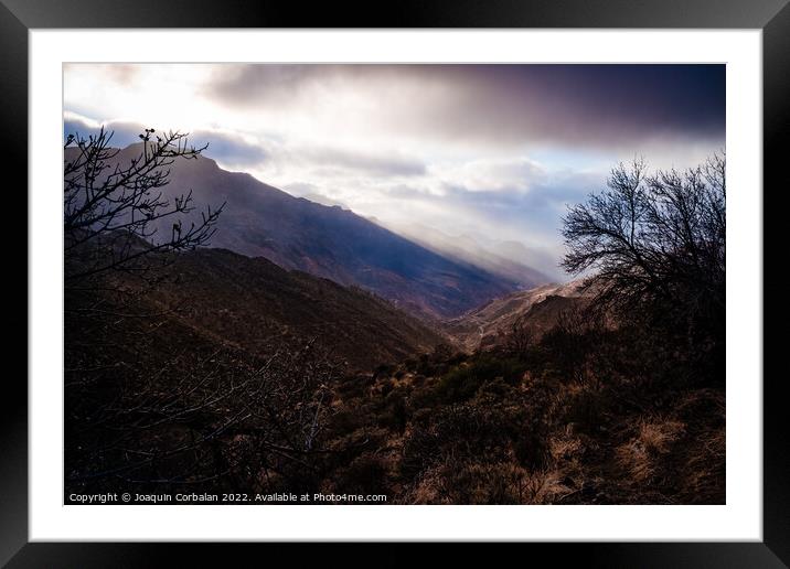 Beautiful valley at sunset with dark hills in the foreground. Framed Mounted Print by Joaquin Corbalan