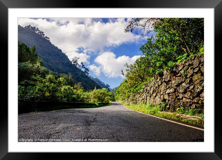 Sunny day on a road between mountains of the Canary Islands, in  Framed Mounted Print by Joaquin Corbalan