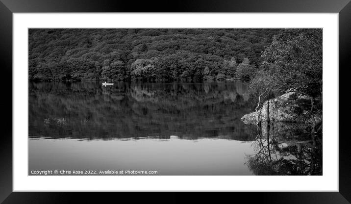 A couple pass in a canoe on Coniston Water Framed Mounted Print by Chris Rose