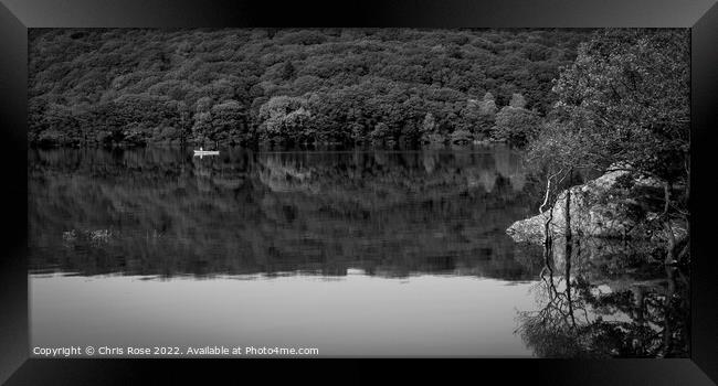 A couple pass in a canoe on Coniston Water Framed Print by Chris Rose