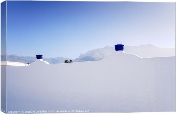 A sunny day to see the mountains behind the whitewashed wall of  Canvas Print by Joaquin Corbalan