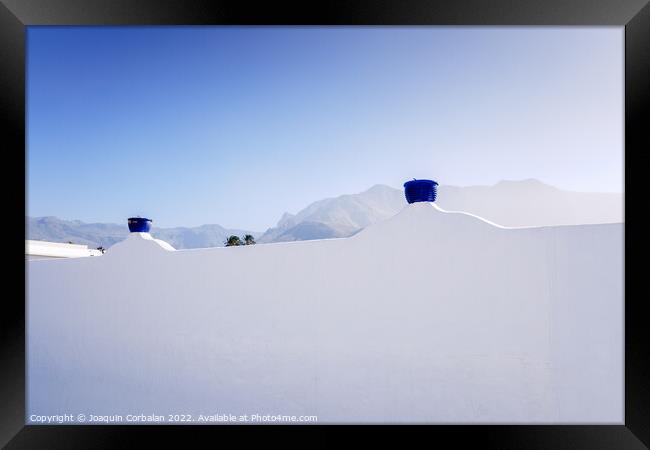 A sunny day to see the mountains behind the whitewashed wall of  Framed Print by Joaquin Corbalan
