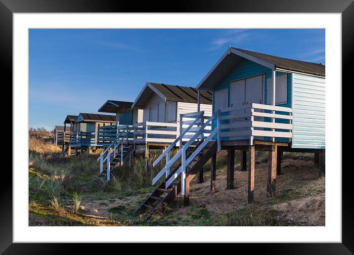 Row of beach huts Framed Mounted Print by Clive Wells