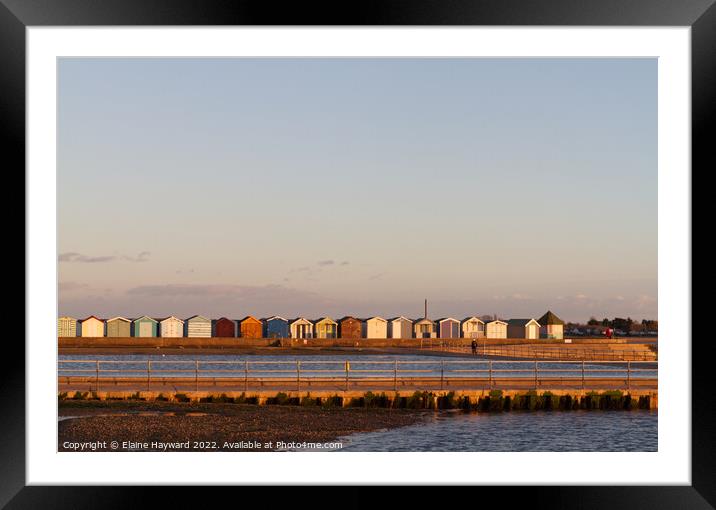 Beach huts at Brightlingsea during golden hour Framed Mounted Print by Elaine Hayward
