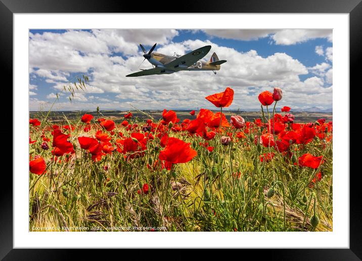 Spitfire fighter war plane flying over a poppy field. Framed Mounted Print by Kevin Hellon
