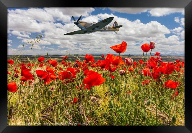 Spitfire fighter war plane flying over a poppy field. Framed Print by Kevin Hellon