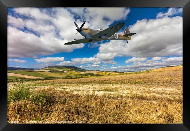 Spitfire fighter war plane flying over a field. Framed Print by Kevin Hellon
