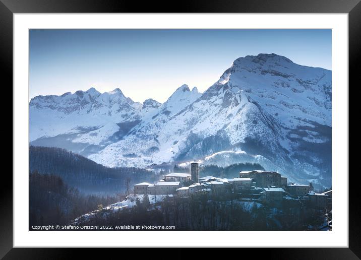 Snowy village and Apuan mountains in winter. Nicciano, Italy Framed Mounted Print by Stefano Orazzini