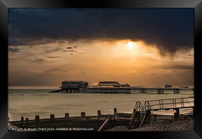 A sunset over Cromer pier in winter Framed Print by Travel and Pixels 