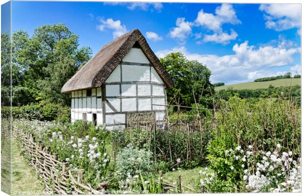 Enchanting Half-Timbered Cottage in a Blossoming G Canvas Print by Roger Mechan