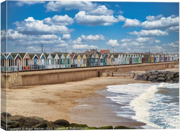 Lively Beach Huts by the Rocky Shore Canvas Print by Roger Mechan