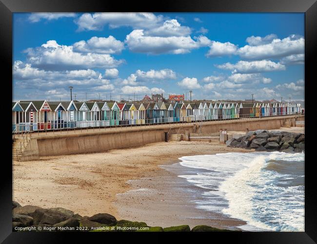 Lively Beach Huts by the Rocky Shore Framed Print by Roger Mechan