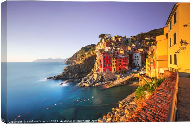 Riomaggiore town, cape and sea at sunset. Cinque Terre, Liguria, Canvas Print by Stefano Orazzini