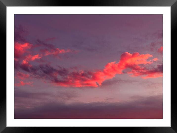 The setting sun lighting up a cloud Framed Mounted Print by Rory Hailes