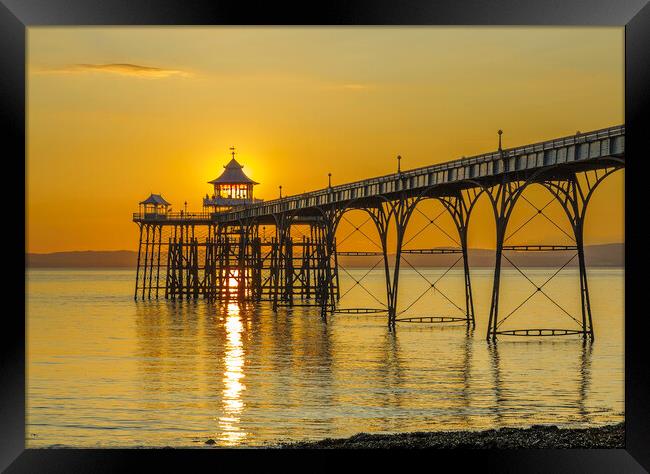 Clevedon Pier with a streak of sunlight Framed Print by Rory Hailes